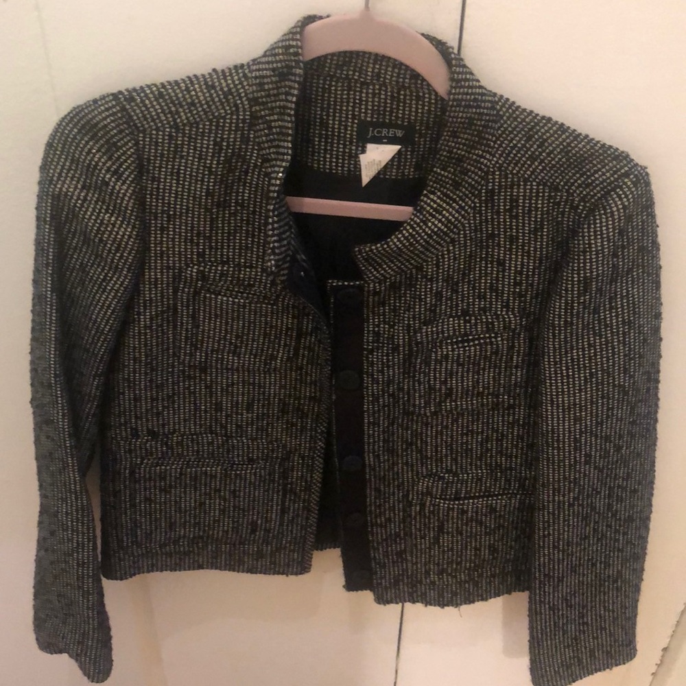 Crewneck metallic jacket with snap closures.